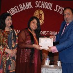 Prof. Dr. Suhail Aftab Qureshi, the chief guest, giving a Gold Medal to a student at the Laurelbank School Prize Distribution.