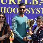 An Athlete of Sir Syed House Receiving ‘Runner – Up Trophy’