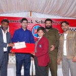 Mr. Amir Karim, Secretary Punjab Chess Association, awarding prize and certificate to a winner of U-14 category.