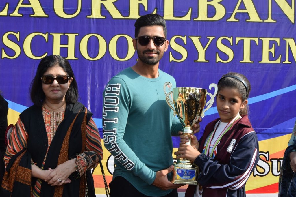 An Athlete of Sir Syed House Receiving ‘Runner – Up Trophy’